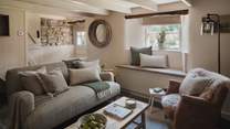 As evenings draw in, sink into the linen sofa in soft green tones