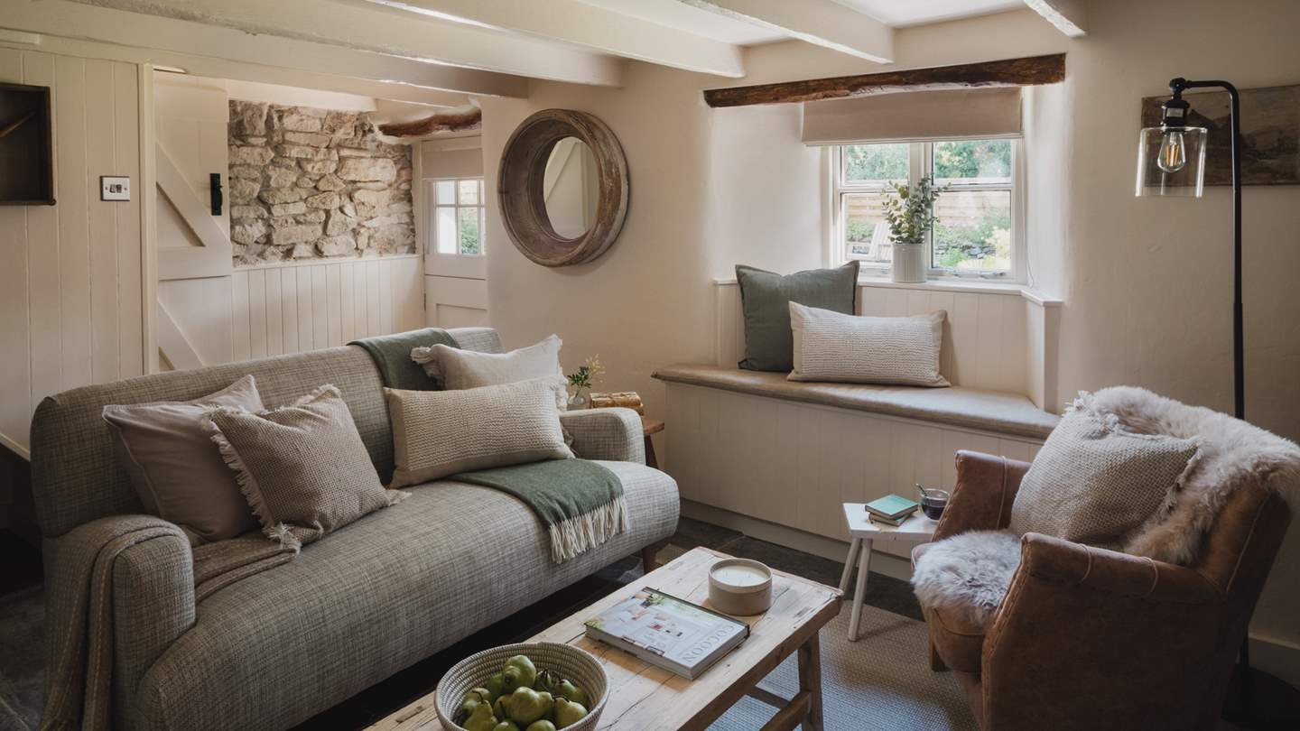 As evenings draw in, sink into the linen sofa in soft green tones