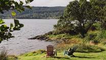 Relax beside the water from the Adirondack chairs 