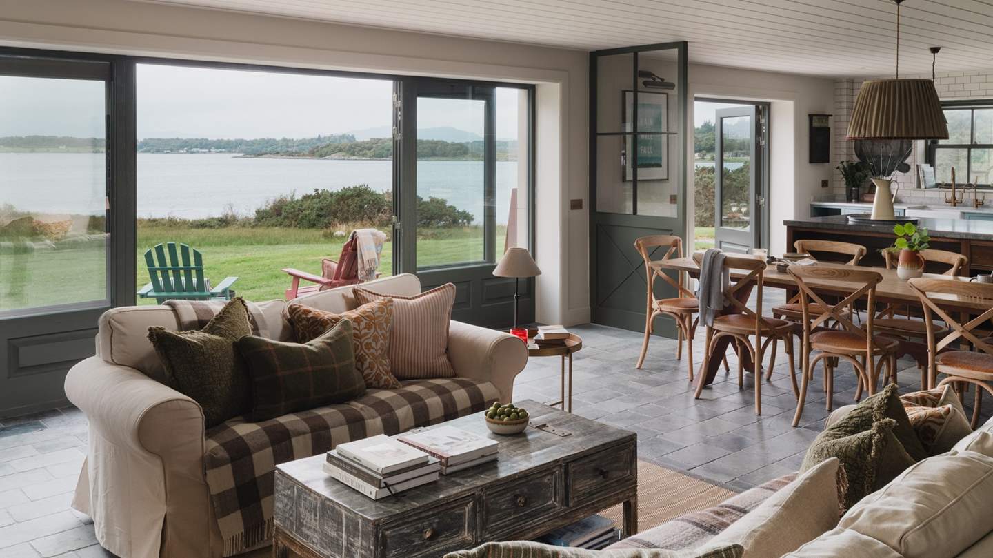 The living, kitchen, and dining area offers a warm and welcoming space for entertaining, dining, and unwinding