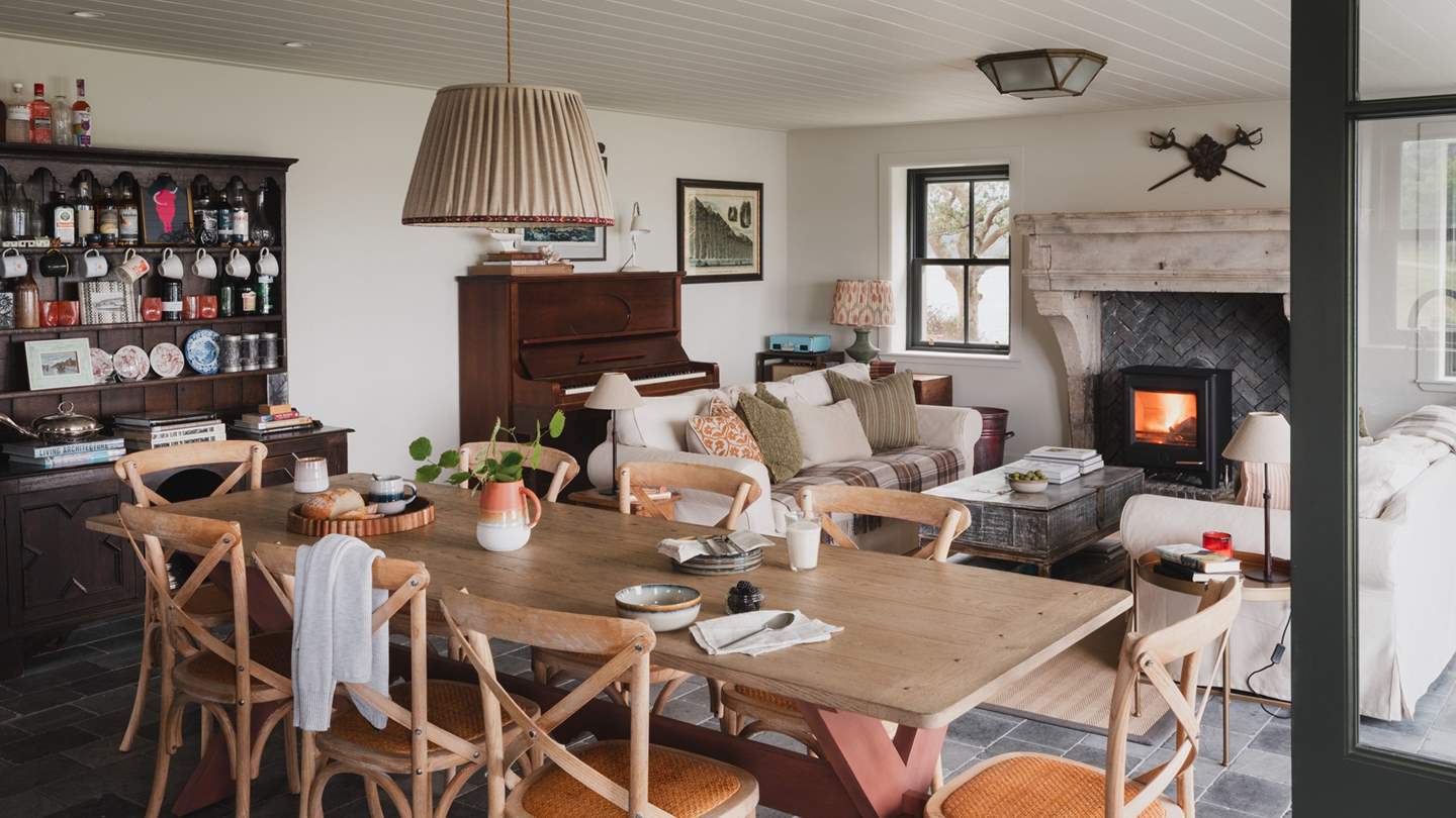 A rustic trestle dining table comfortably seats eight for relaxed brunches and flavourful suppers