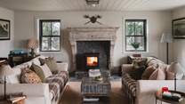 Discover a cosy wood burning stove nestled within an antique Belgian fireplace