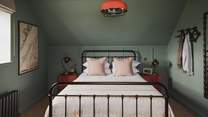 Evoking a dreamlike stillness, teal tones embrace the third bedroom
