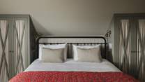 The super-king bed is nestled between two bespoke wardrobes