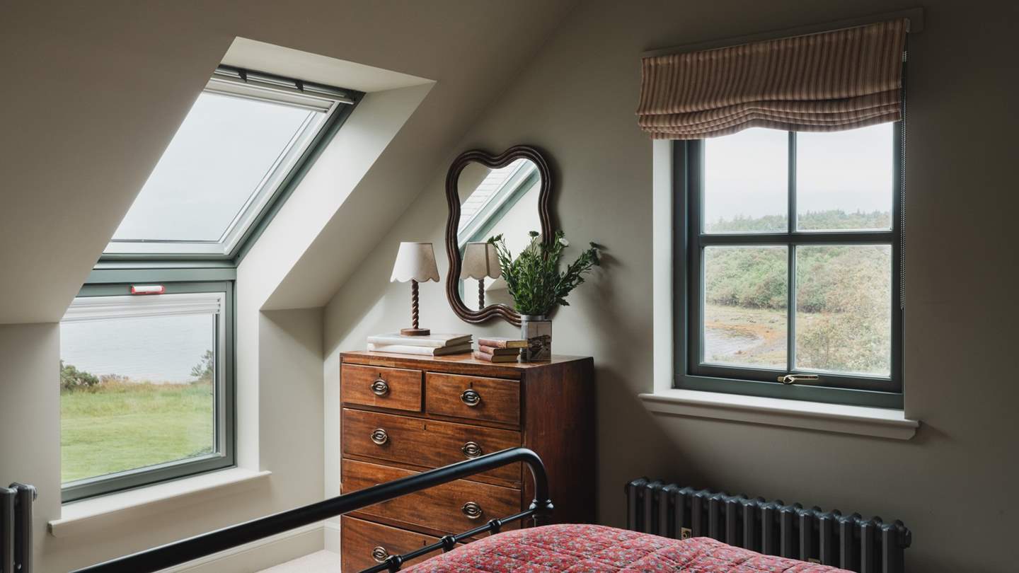 At the foot of the bed, you’ll find an antique chest of drawers 