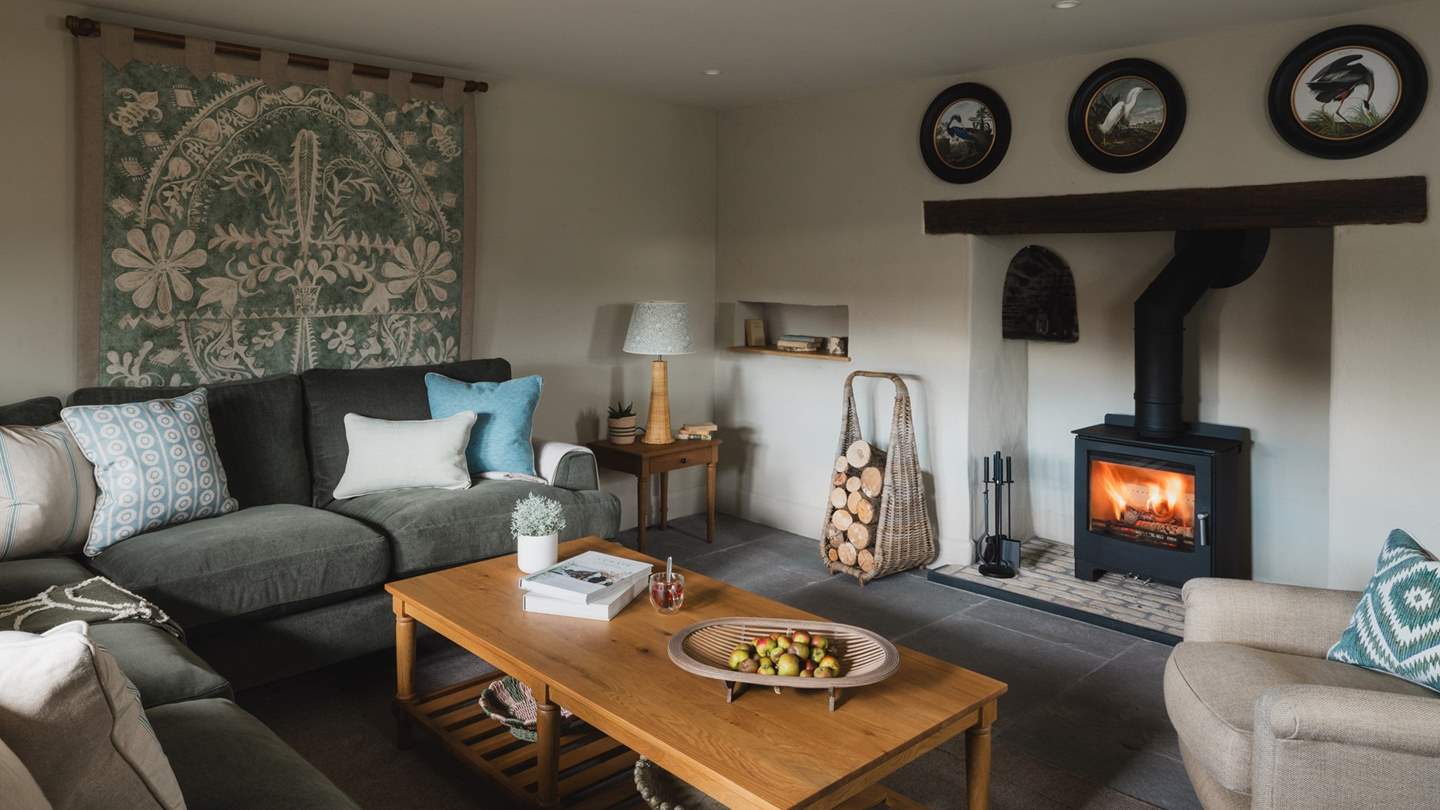 This space features another handsome wood burning stove and large Smart TV