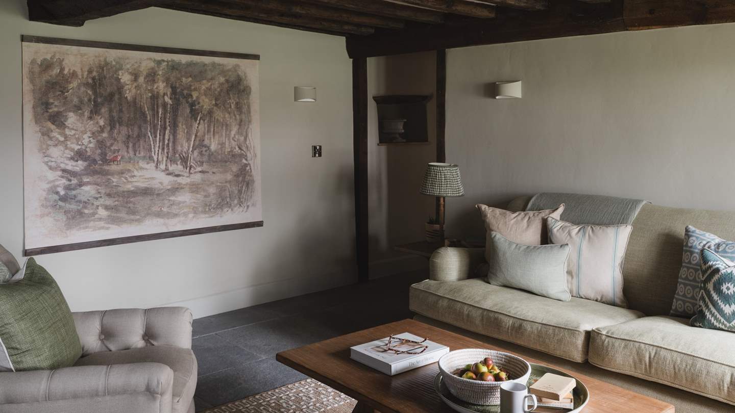 The space is a picture of farmhouse perfection, with traditional beams and natural stone