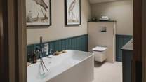 The second and third bedroom share access to the family bathroom, beautifully panelled in soothing shades of teal