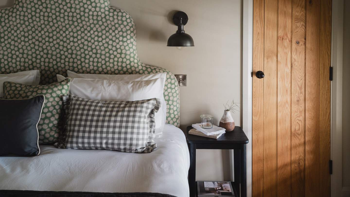 A wall‑mounted TV allows for leisurely mornings in bed