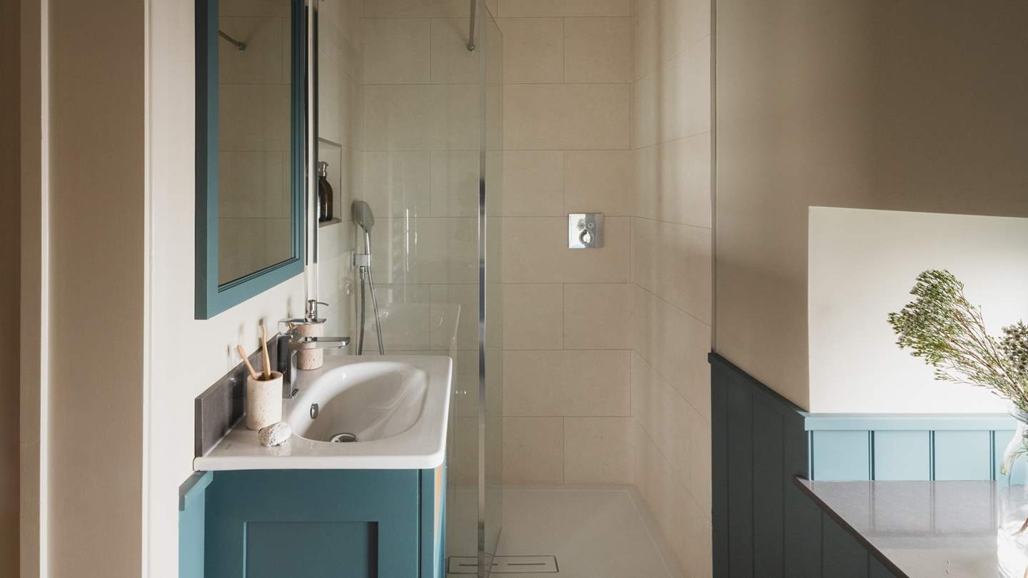 Completing the room, an ensuite shower adds an extra touch of convenience, with a large shower and heated towel rail