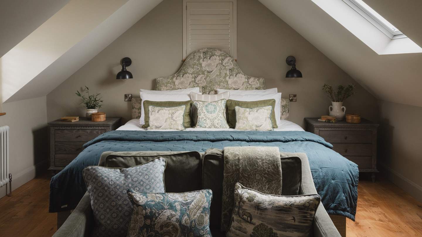 Bathed in soft hues of green and blue, the master bedroom evokes a calming sanctuary for blissful repose