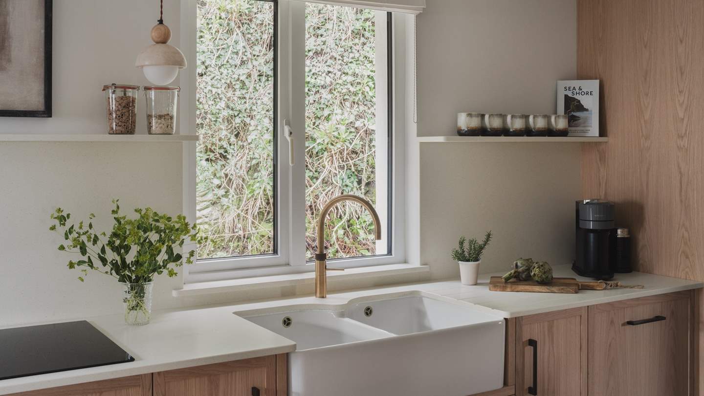 The kitchen features an induction hob, combi built-in microwave, and Nespresso coffee machine