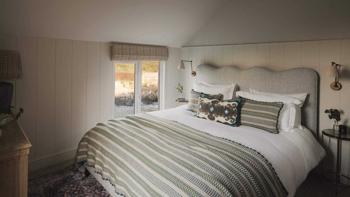 The second bedroom is a picture of perfection with a dual aspect over the luscious garden and seascape
