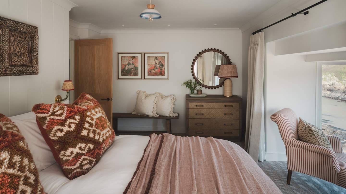 Taking centre stage, a super king bed is dressed in the finest linens and can be transformed into two singles upon request