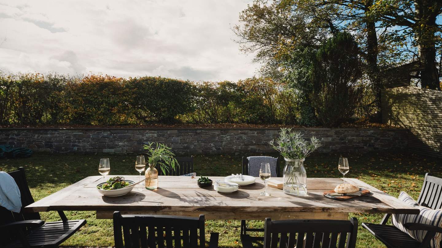 Gather around the dining table for six for alfresco feasts in the dappled sunlight