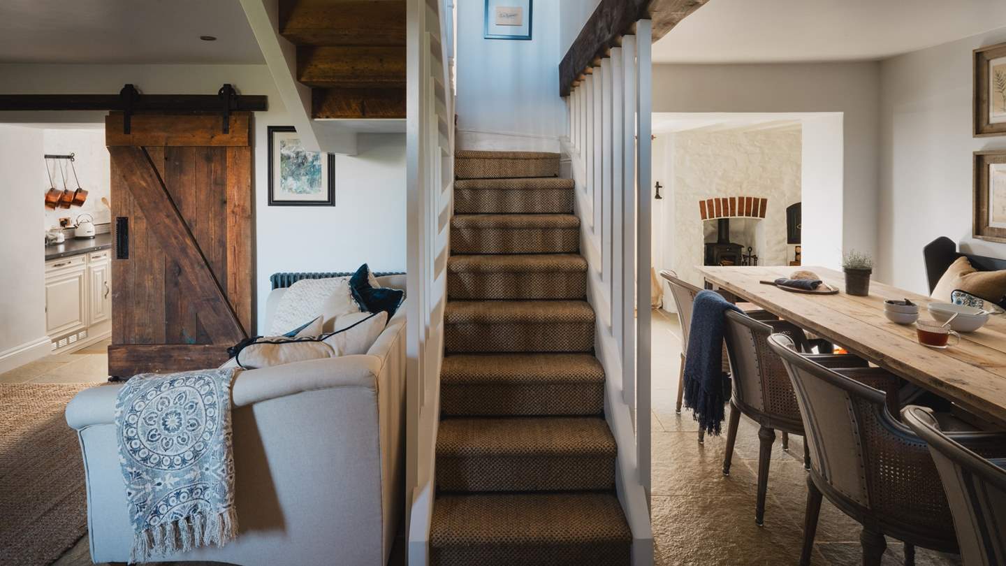 In a beautiful wraparound design, the kitchen and dining areas hug either side of the living room