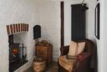 For hushed moments, a separate snug offers a cosy leather armchair and an additional wood burning stove