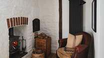 For hushed moments, a separate snug offers a cosy leather armchair and an additional wood burning stove