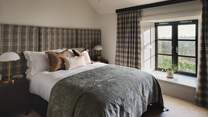 Equally inviting, bedroom three offers restful calm after dark, with a king size bed and grand tartan headboard in gentle tones