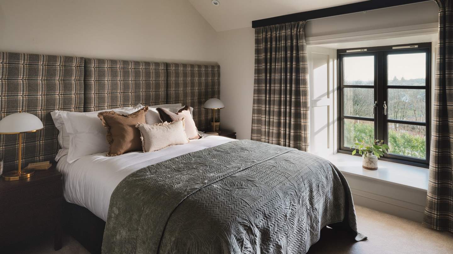 Equally inviting, bedroom three offers restful calm after dark, with a king size bed and grand tartan headboard in gentle tones