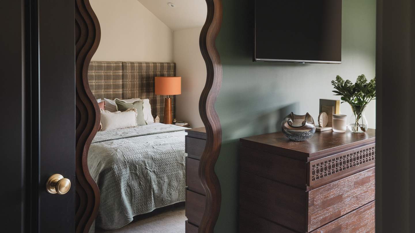 For storage, there’s a chest of drawers, and a full length wavey mirror