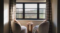 Admire rolling country vistas from the two accent chairs