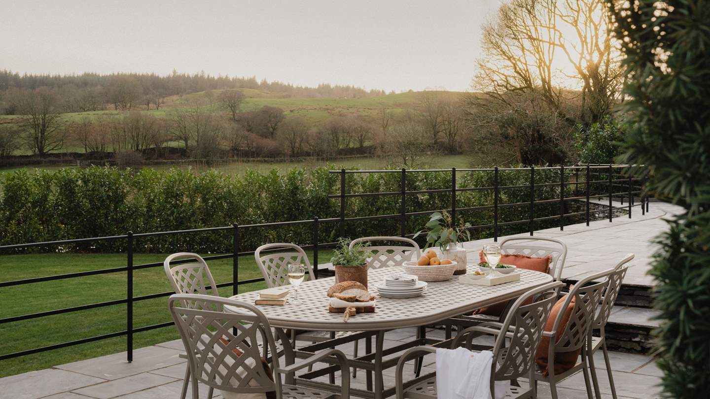 Uncover a dining table for eight and a large gas barbeque for grilling summertime delights