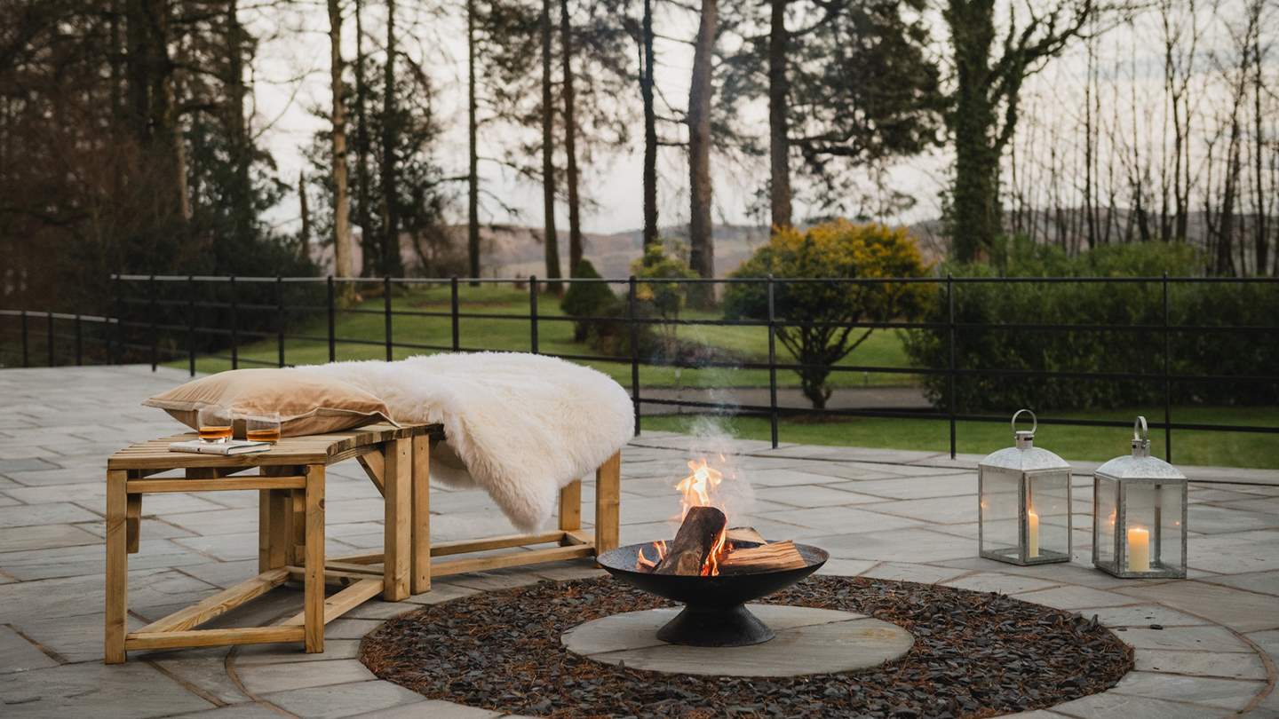 Relish cosy conversation gathered beside firepit embers