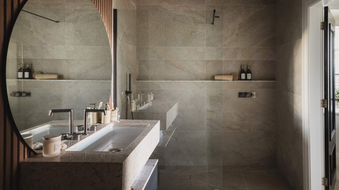 Within the ensuite bathroom, uncover a large walk-in rainfall shower 