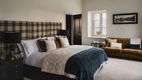 With a super king bed and large tartan headboard, the master bedroom is a soothing space to rest 