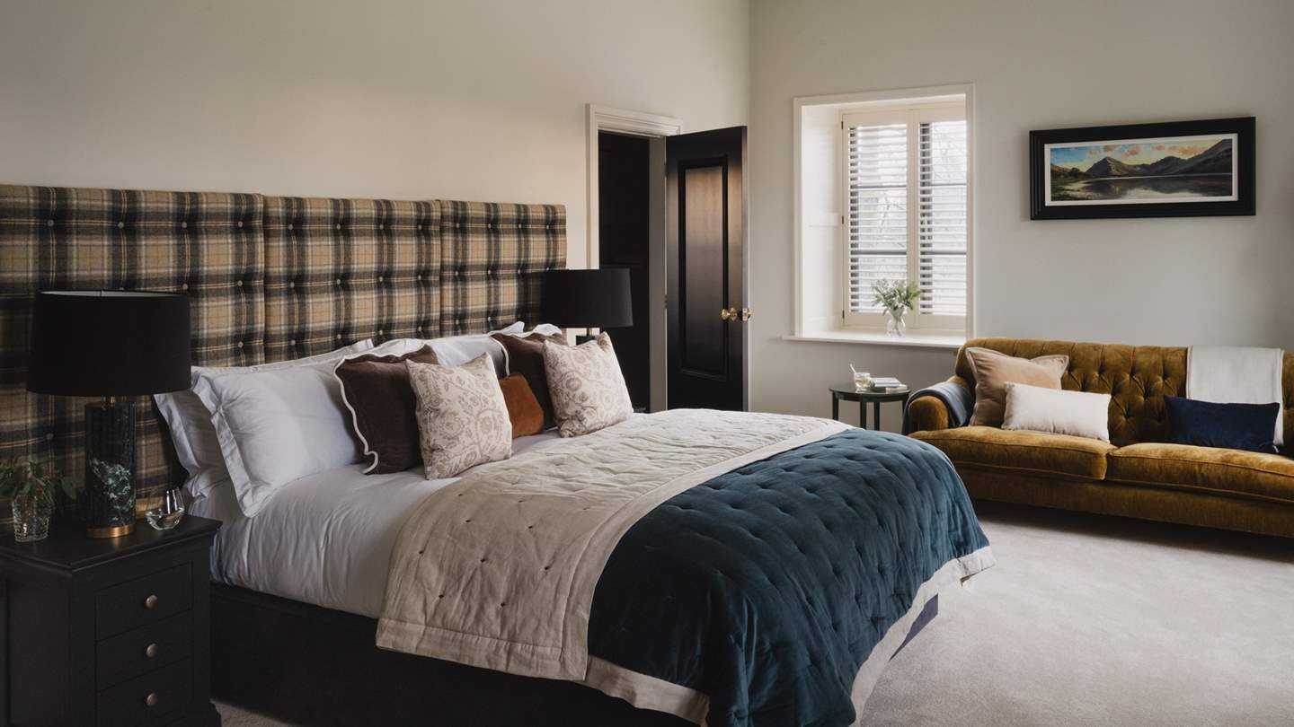 With a super king bed and large tartan headboard, the master bedroom is a soothing space to rest 