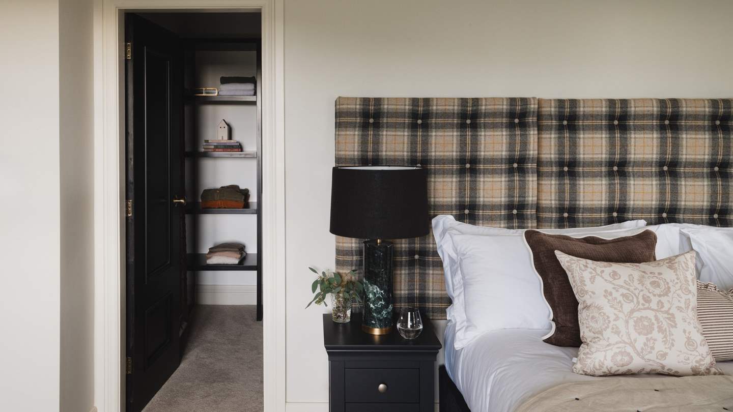 For stowing belongings, you’ll find a chest of drawers, with additional storage in the walk-in wardrobe