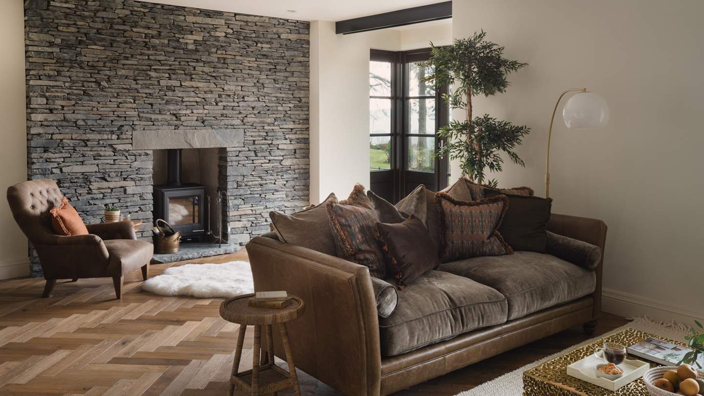 Two leather sofas await for complete comfort - please note, the fireplace is not available for guest use