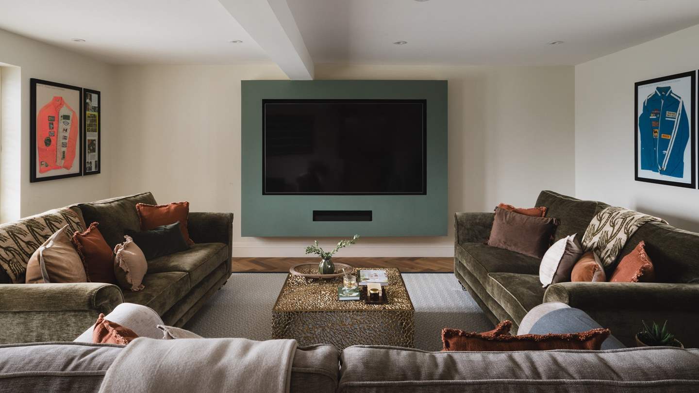 The media room is a soothing space to retire, with three sumptuous sofas centred before an 85” Smart TV
