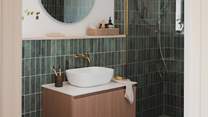 On the lower ground floor you’ll find a sleek shower room in soft ocean hues