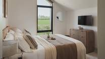 Bedroom four is home to a super king zip-and-link bed and a peaceful outlook across the Cornish countryside
