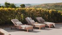 Recline on the inviting sun loungers with a delightfully chilled tipple and a captivating read