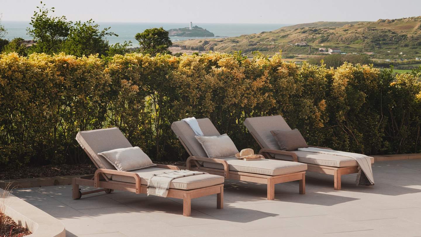 Recline on the inviting sun loungers with a delightfully chilled tipple and a captivating read