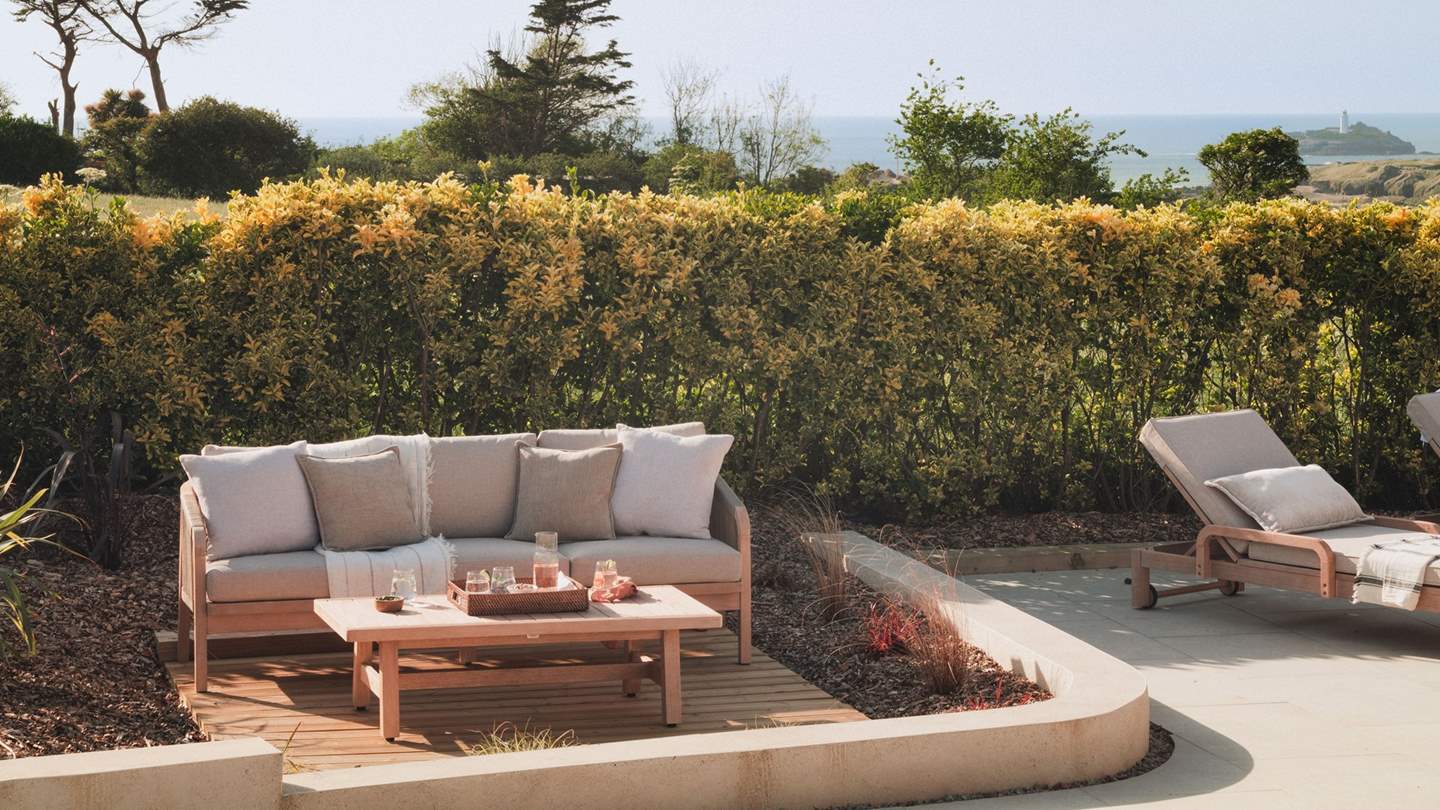 A beautifully styled outdoor sofa and low table beckon