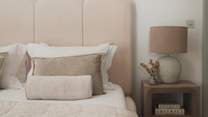 Centred around a lavish super king bed with a softly sculpted cream fluted headboard