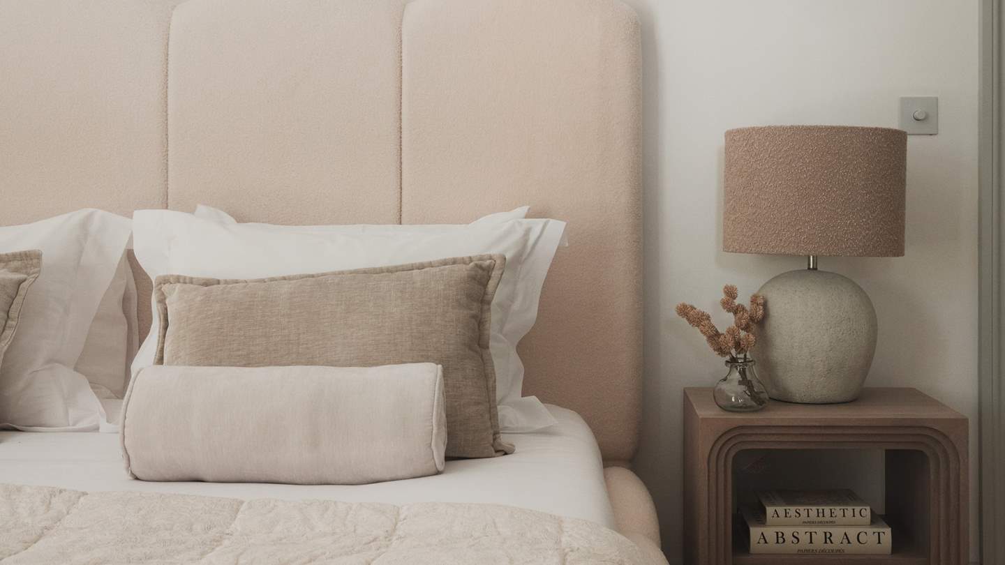 Centred around a lavish super king bed with a softly sculpted cream fluted headboard