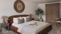 Residing on the first floor, the spacious second bedroom features a luxurious super king bed 