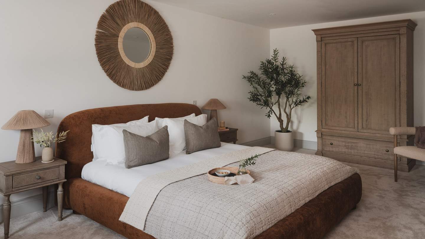 Residing on the first floor, the spacious second bedroom features a luxurious super king bed 