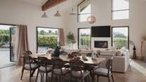 Vaulted ceilings, skylights, and large bi-fold doors allow natural light to flood the room
