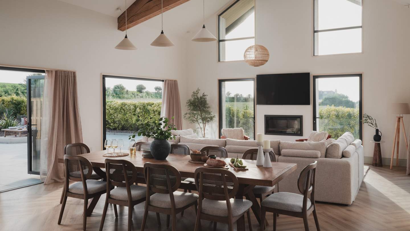 Vaulted ceilings, skylights, and large bi-fold doors allow natural light to flood the room