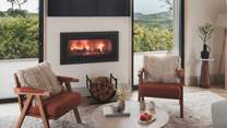 A modern wood burning stove evokes a sense of familiar warmth after windswept rambles along the expansive sands of Gwithian