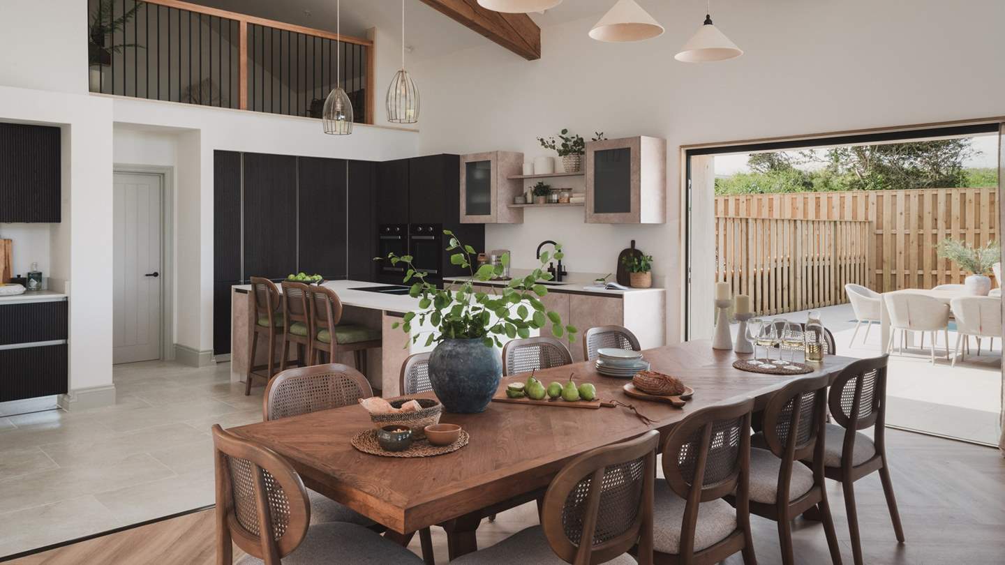 An inviting dining table comfortably seats ten for long, leisurely suppers, where conversation flows effortlessly into the evening...