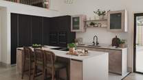 Three bar stools sit at the kitchen island, creating a natural hub for watching meal preparations take place