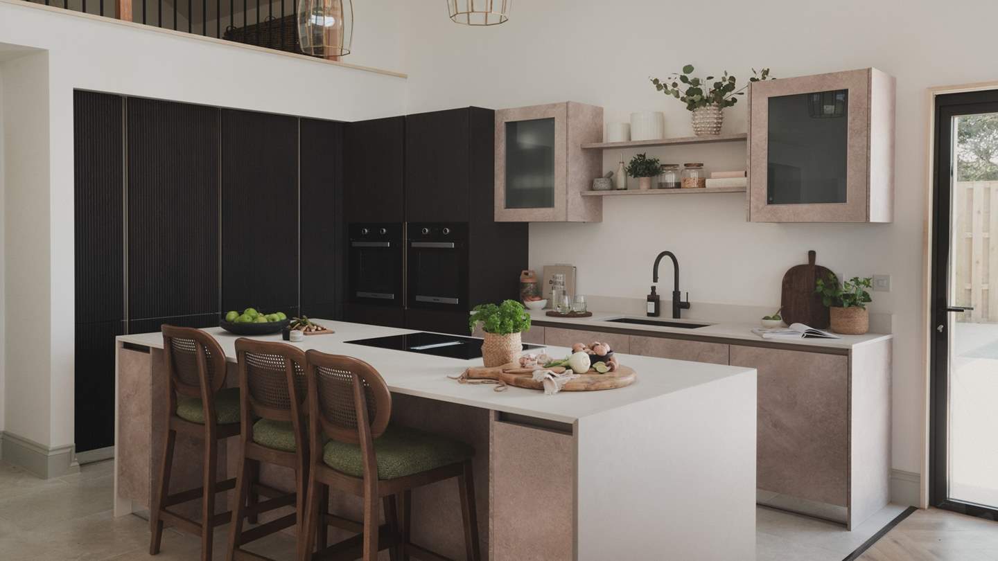 Three bar stools sit at the kitchen island, creating a natural hub for watching meal preparations take place