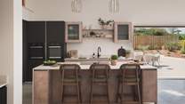 Beyond the dining area lies a sleek kitchen, fully equipped and designed for easy entertaining